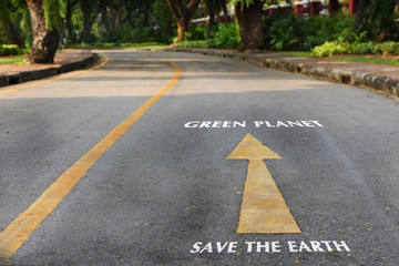 Words of save the earth and green planet on the road at the park, earth day concept
