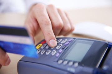 Businessman using payment terminal