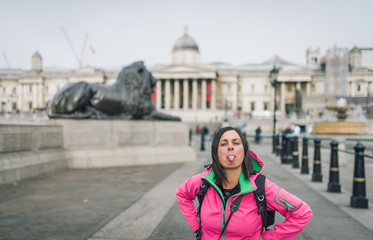Fototapeta premium London tourist woman on Trafalgar Square in front of National Gallery smiling happy laughing having fun. Beautiful girl on travel vacation, London, England, United Kingdom.