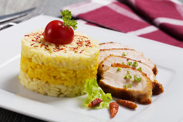 Portion of risotto with roasted chicken.