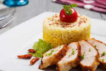Portion of risotto with roasted chicken.