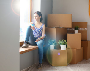 Girl sitting on windowsill at new home