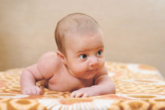 Newborn Baby Trying to Crawl on a blanket