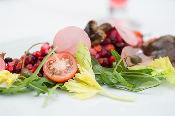 Vinaigrette Russian Salad made of chopped beets, carrots, onion, beans, peas, seasoned with...