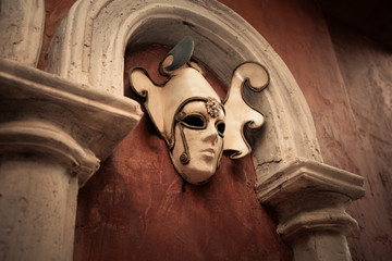 Venetian mask on a brown wall