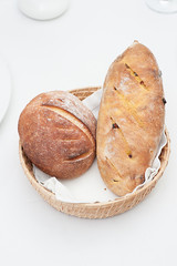 Two Loaves of Homemade Bread in a Basket, isolated