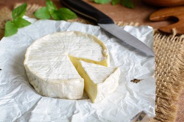 Cheese wheel on wooden table