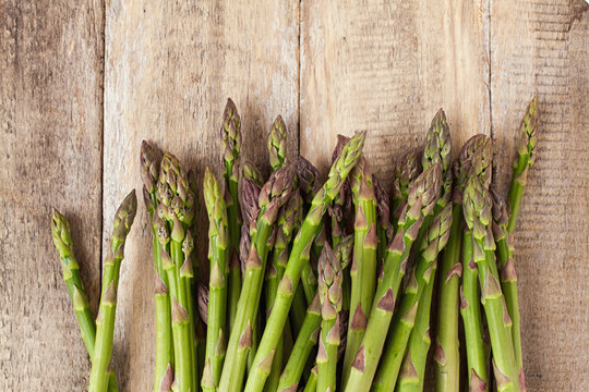 fresh asparagus on wood background