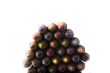 colored pencils on a blank sheet of paper, ready to be used in design