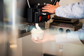 Hand and Ice cream machine production detail
