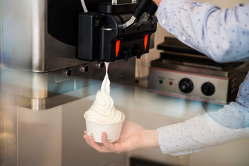 Hand and Ice cream machine production detail