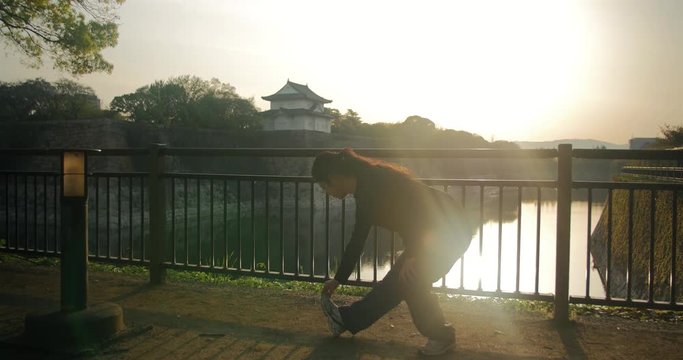 Young Japanese running preparing mentally before begining to race