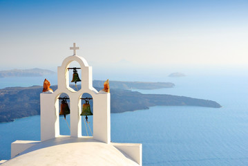Unique bell tower on Santorini Island, Greece. The view toward Caldera sea waiting for sunset. - obrazy, fototapety, plakaty