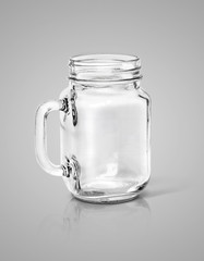 Clear glass bottle isolated on gray background