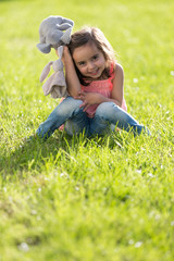 Fototapeta premium Sweet little girl outdoors playing