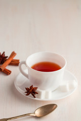 cup of tea with teaspoon and cubic sugar