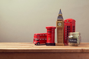 Travel to Great Britain concept with souvenirs and money box jar. Planning summer vacation, money...