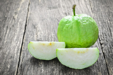 Slice of green Guava on wooden table