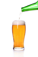 Light cold beer in a glass glass on a white background