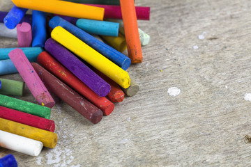 Close up of multicolored oil pastels on artist workplace
