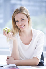 Blond woman, blue eyes and green apple; Nutritional value