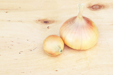 The bulbs of onion on a wooden board
