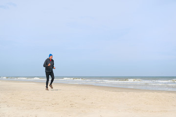 Fototapeta na wymiar Senior man running at beach