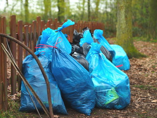 Trash bags full of litter in a forest (Clean Up The World action in Prague, Czech Republic)