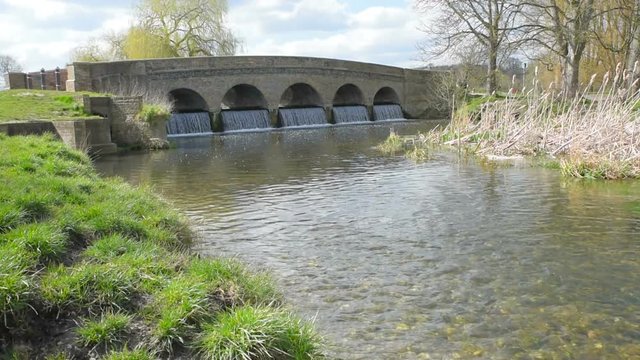 The river Cray flows over a weir at Five Arches Bridge  at Foots Cray Meadows in Sidcup, Kent,UK