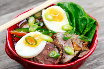 Duck noodles with egg, vegetables and duck meat in bowl