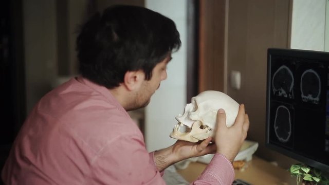 Curious doctor looking into a skull
