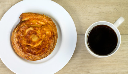 Cup of coffee and cheese bun at morning breakfast