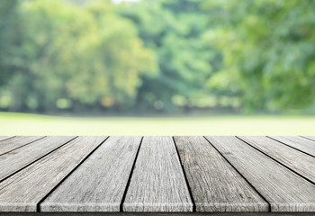 Empty wooden table with blurred city park on background, natural background with bokeh / spring concept