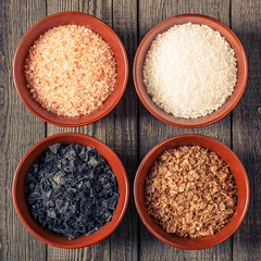 Variety of Different Sea Salts in ceramic bowls.