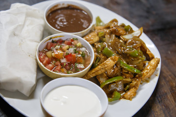 mexican dish with salad and frijoles bowl