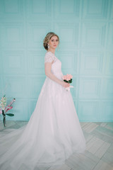Fototapeta premium Portrait of bride in flower decor, studio photo. Beautiful Bride portrait wedding makeup and hairstyle, fashion bride model jewelry and beauty girl face, gorgeous beauty bride, studio, flower series