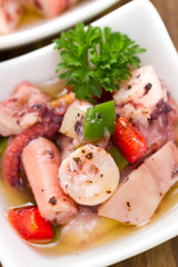salad with octopus sea food on small white dish