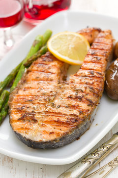 grilled salmon with lemon and vegetables on dish