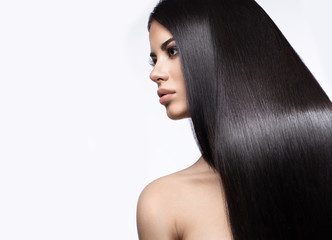 Beautiful brunette girl in move with a perfectly smooth hair, and classic make-up. Beauty face.