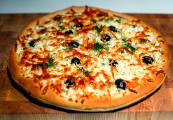 Cheese pizza with olives and herbs