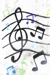 treble clef painted on a white wall