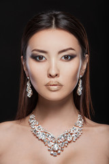 Beautiful young asian woman with elegant earrings and necklace