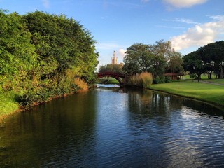 Fototapeta na wymiar bitmore golfcourse bridge on a canal, hotel tower to the end