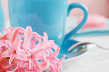 Cup of black coffee and pink flower