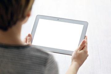 Young woman using tablet at the table