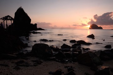 Calm morning at the beach watching rock formation at sunrise - Powered by Adobe