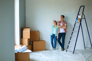 Portrait of young couple moving in new home