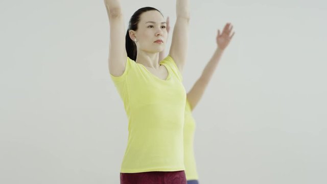 Slender fit women doing yoga on exercise 