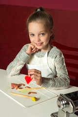 little girl with craft clay heart
