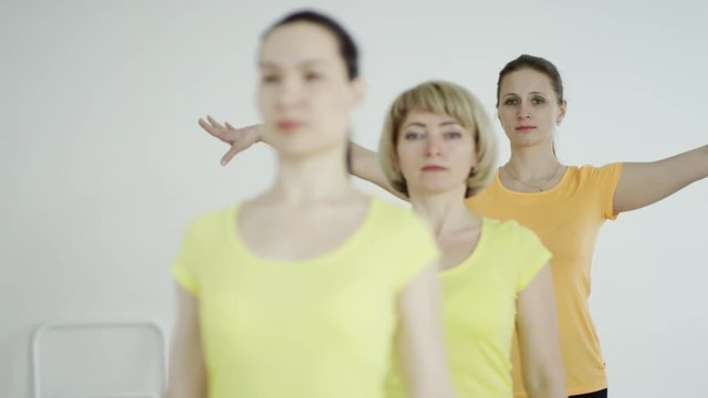 young women are practicing the Accomplished Pose 